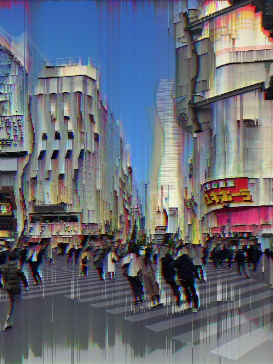 The same frame after MODUL8: buildings dissolved into vertical streaks, colour fringing on every edge, the crossing stretched into ribbons.